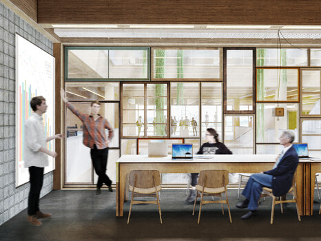 Beispielbüro im Gründungszentrum | © BIS/Partner und Partner Ein Innenraum mit einem großen Holztisch und einer großen Leinwand, an der zwei Personen einen Vortrag halten | © BIS/Partner und Partner